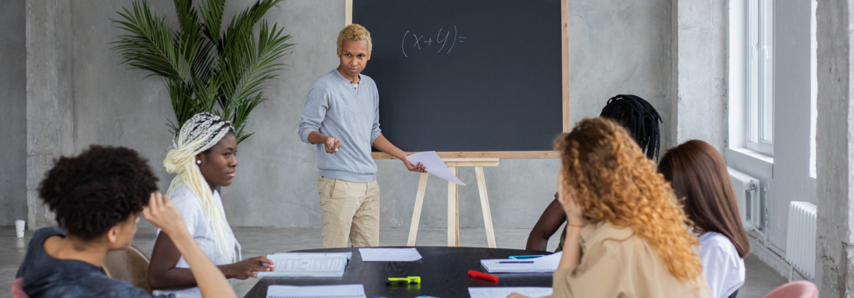 Math tutoring Richmond session with tutor teaching students at a whiteboard in a classroom setting