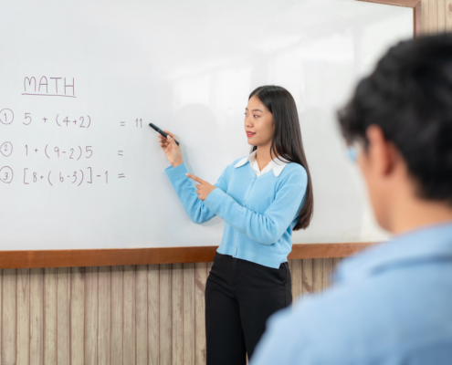 female tutor writing on board math tutor Richmond